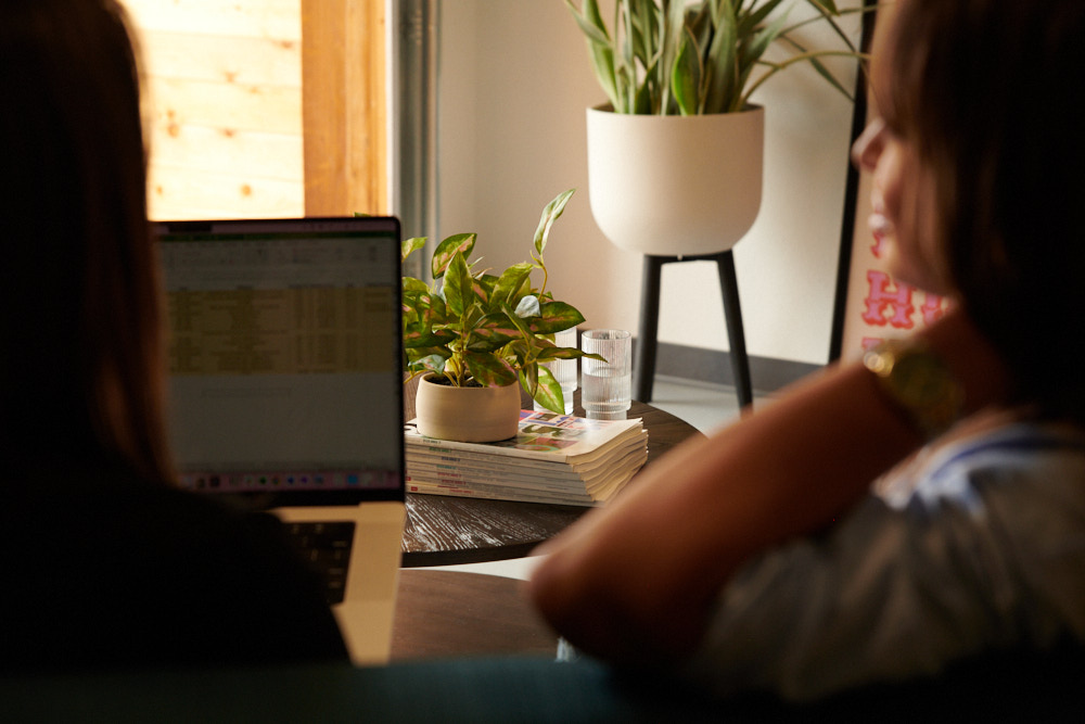 two-employees-sitting-with-plants